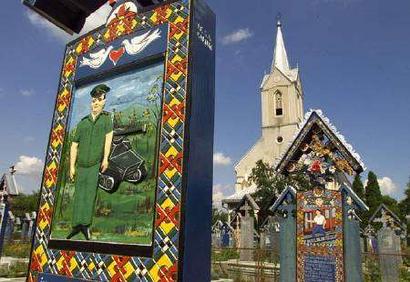 View of the Merry Cemetery of Sapanta (435 miles northwest of Bucharest) in this July 3, 2004 file picture. Bursting with colour, life and history, hundreds of brilliantly decorated wooden crosses have marked the graves of villagers since an imaginative local wood carver started this unique tradition in the 1930s. REUTERS/Bogdan Cristel